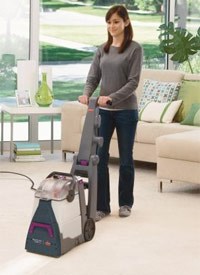Woman cleaning her carpets with the carpet rental machine by Pawsitively Clean BISSELL