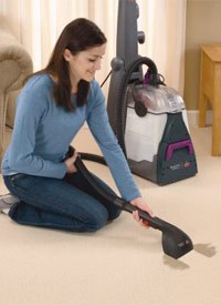 Woman using attachment tool for Pawsitively Clean Carpet Cleaning Machine Rental